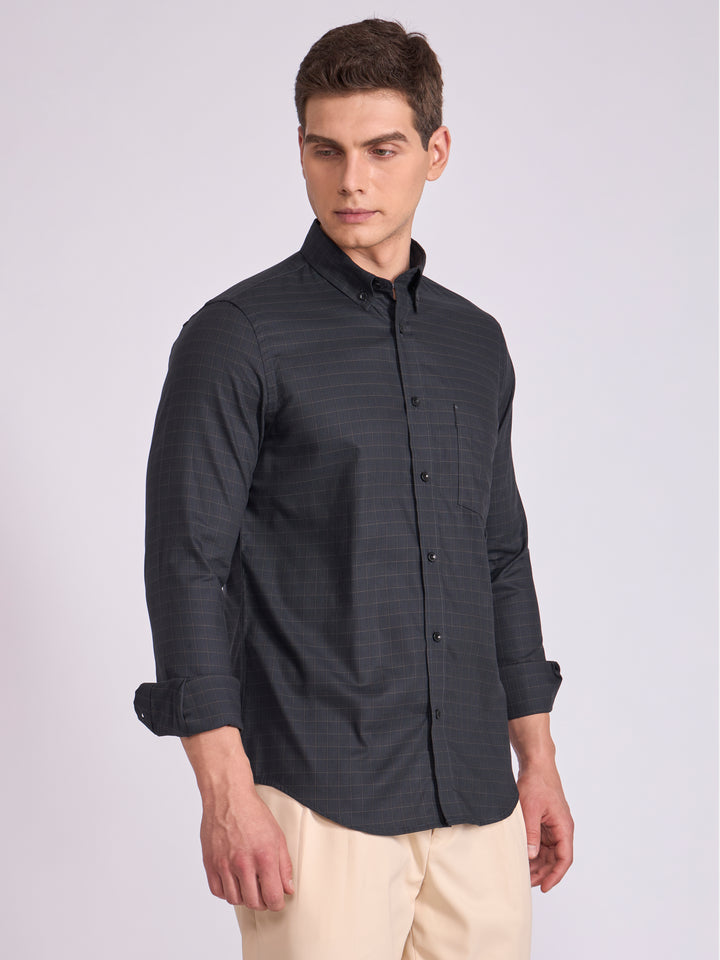 Man wearing a dark slate  gray checkered shirt.