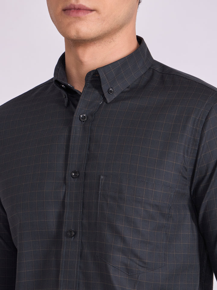 Man wearing a dark slate  gray checkered shirt.