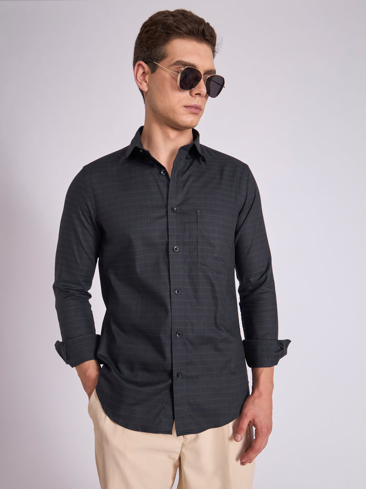 Man wearing a dark slate  gray checkered shirt.