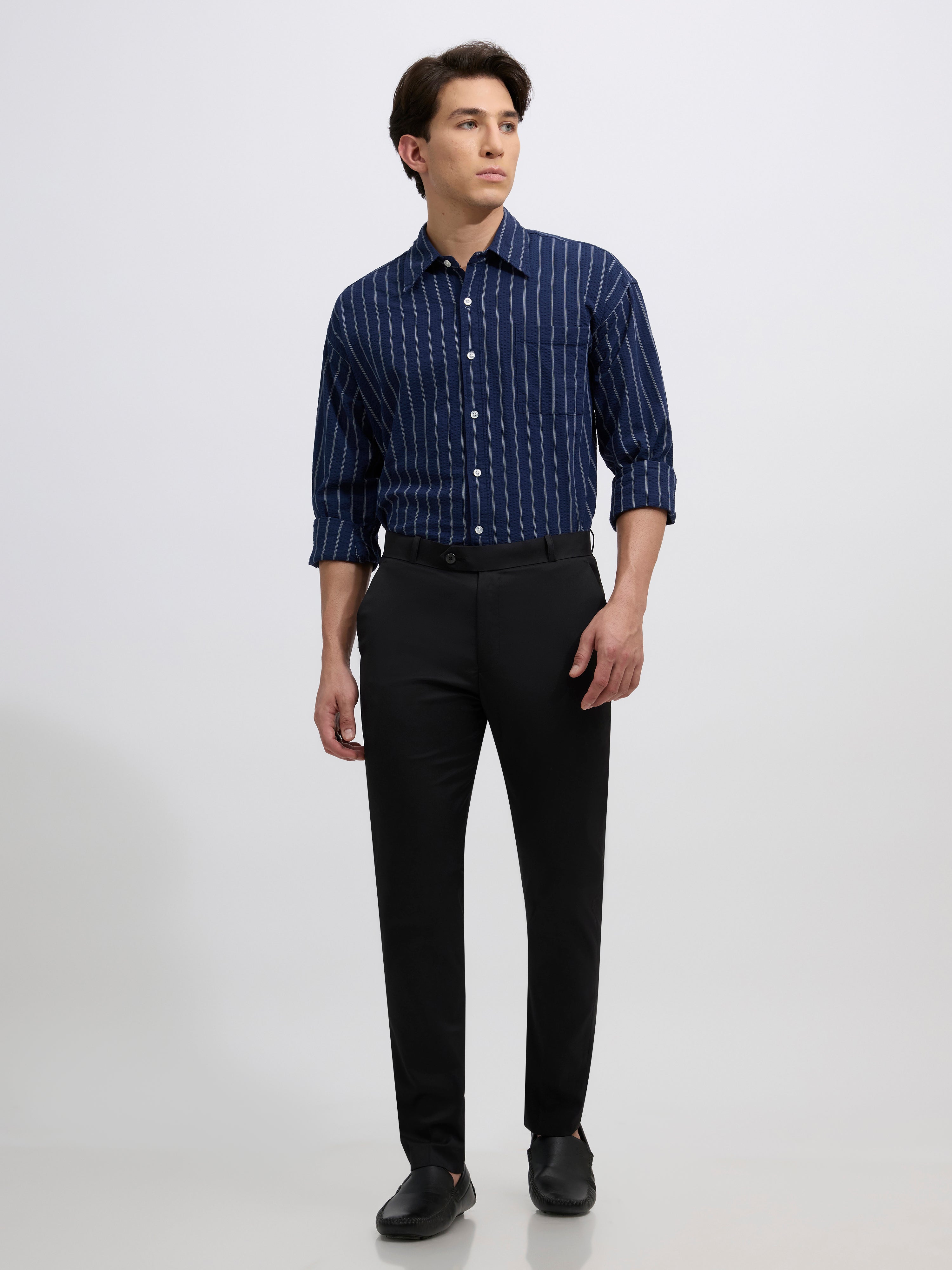 men's black skinny fit trousers blended with polyster and spandex - paired with a black top and black shoes